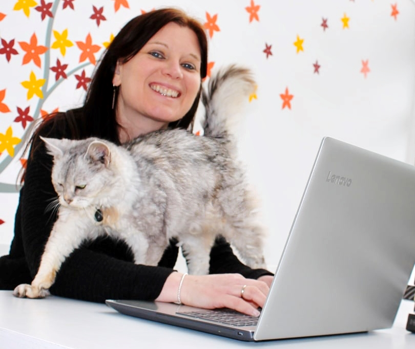 Jenny Seal with a cat on her laptop